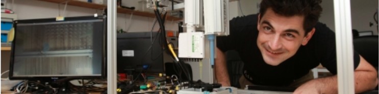 Nicholas Wagner working in a lab on an early Opentrons prototype in Shenzhen, China.